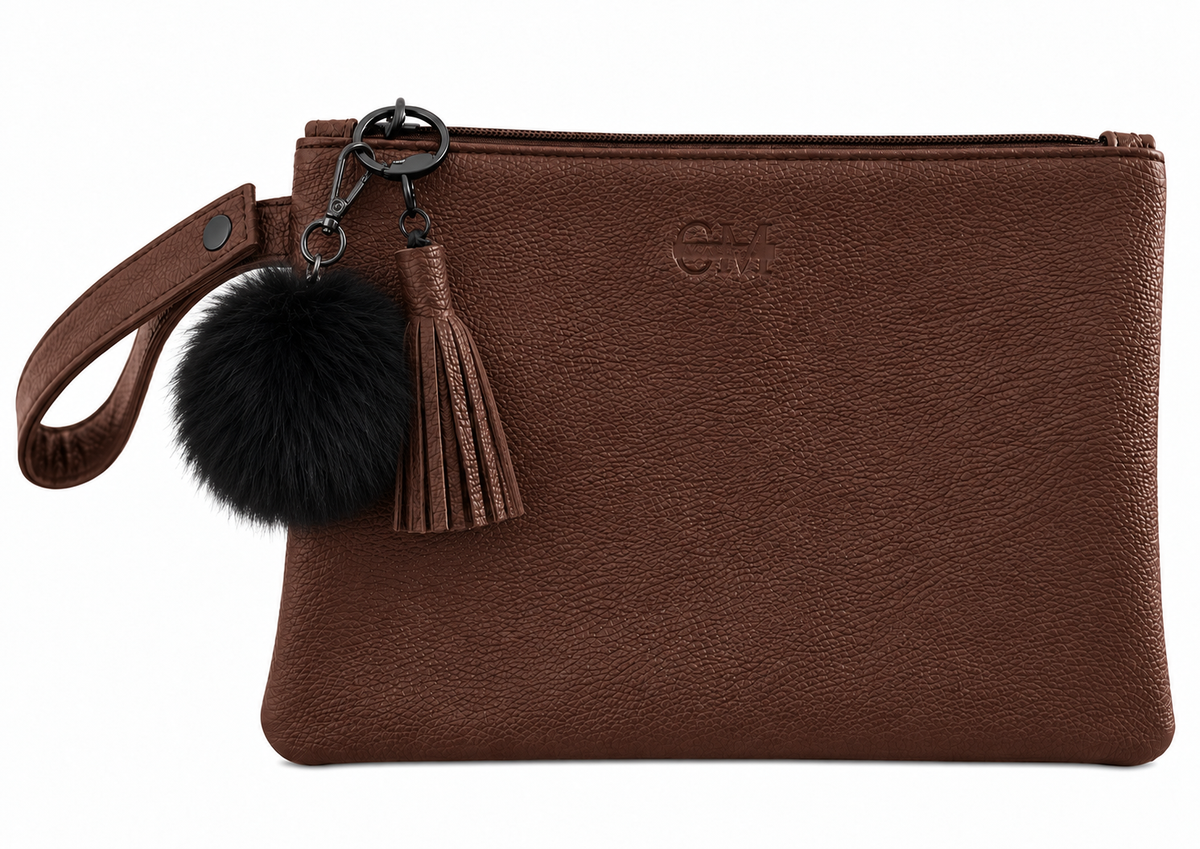 Coco Mae Black bag charm on a Coco Brown Tassel Clutch