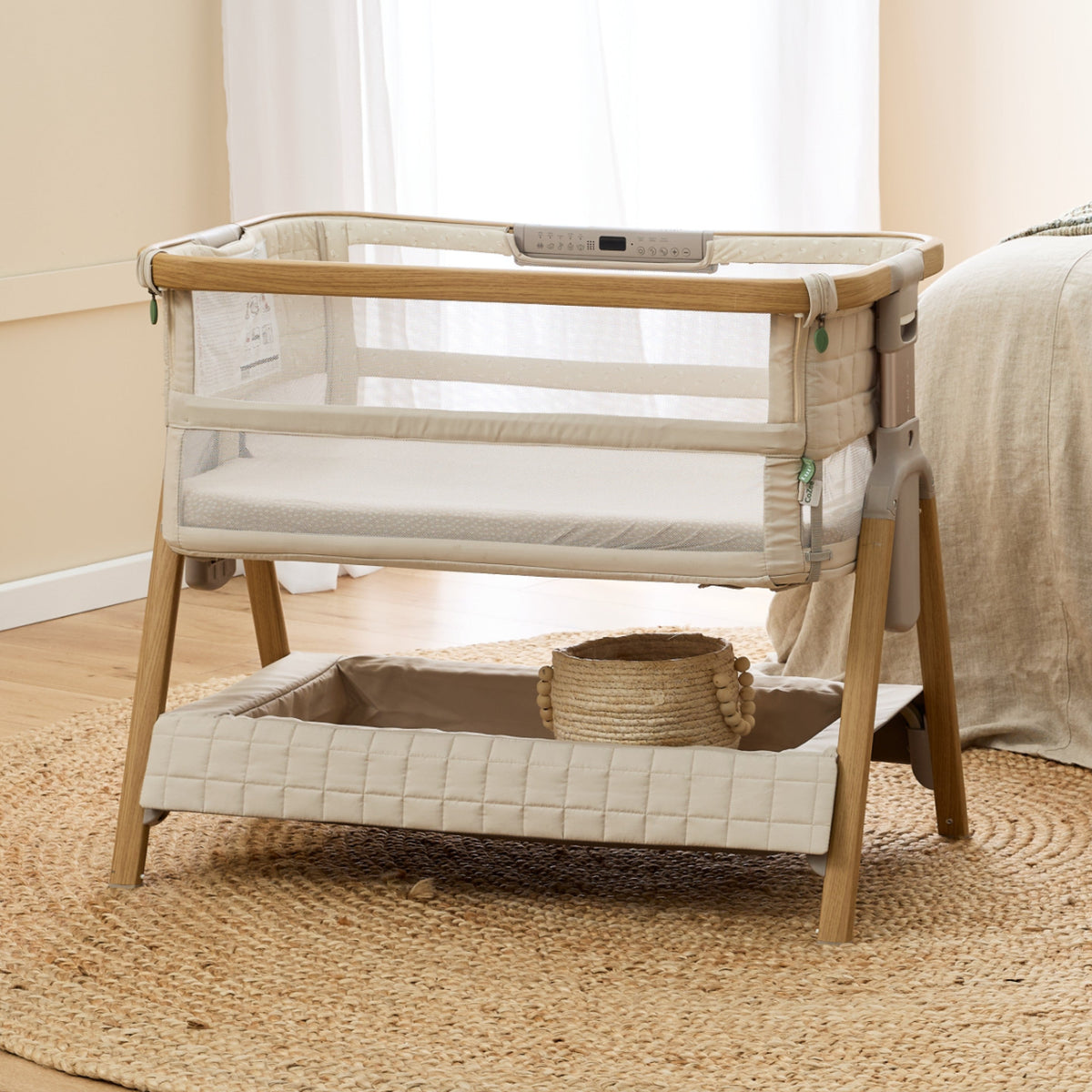 CoZee Breeze Sense bassinet in a bedroom showing the under-bassinet storage
