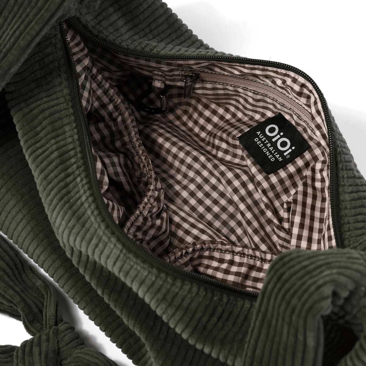 OiOi Luna Crossbody worn across the body (shown in Moss Green)