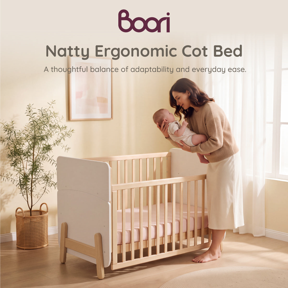 Boori Natty Ergonomic Cot Bed overview with mum lifting baby