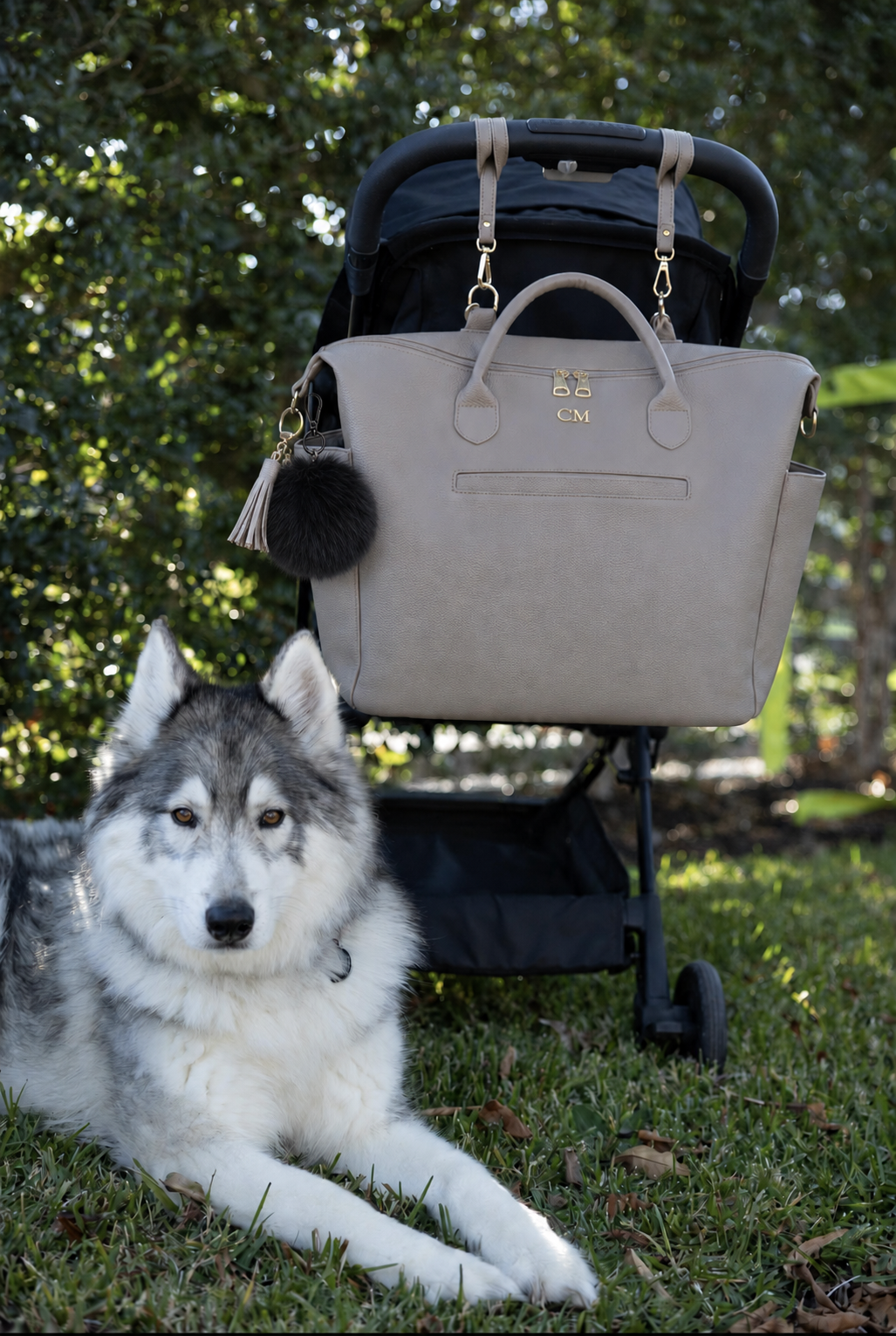 Coco Mae bag charm on a tote nappy bag with a pram