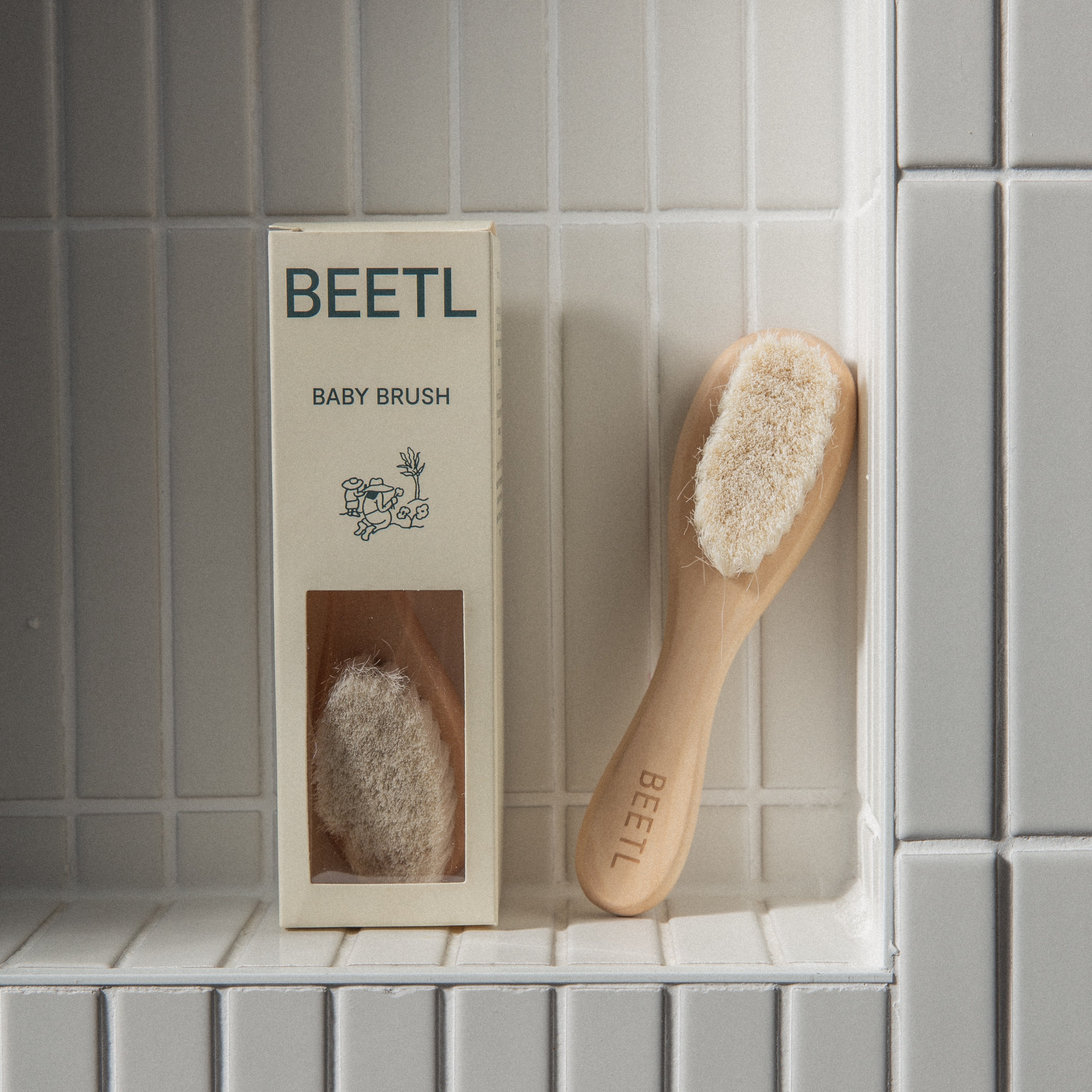 BEETL Baby Brush being used on newborn baby's hair