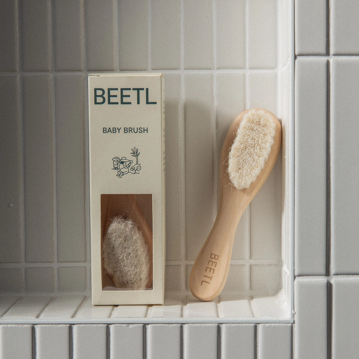 BEETL Baby Brush being used on newborn baby's hair