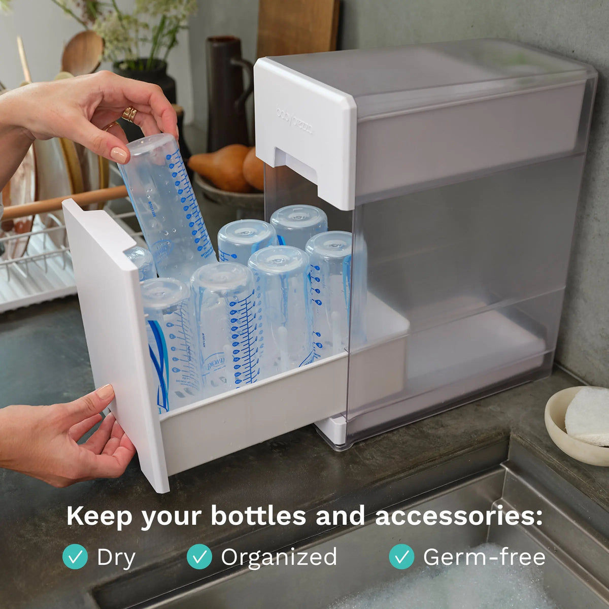 Loading bottles into the Baby Brezza Covered Drying Rack