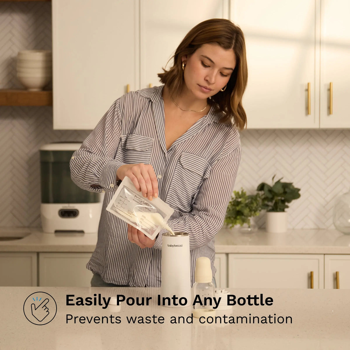 Pouring breast milk from a Baby Brezza storage bag into a bottle