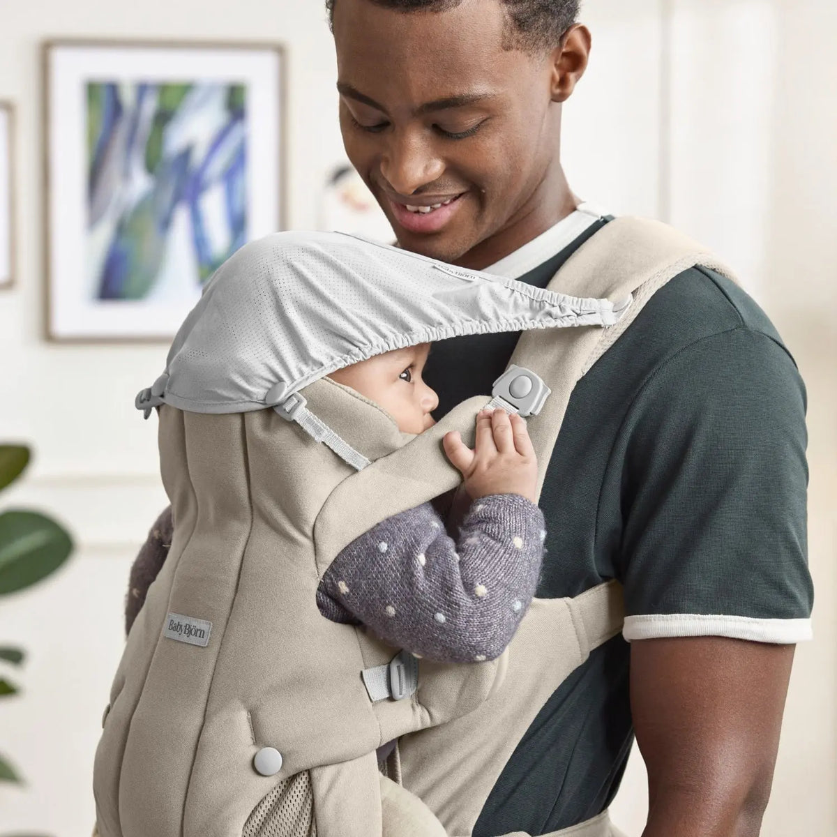 BabyBjorn Baby Carrier Hold Sand Grey with the integrated shade in use