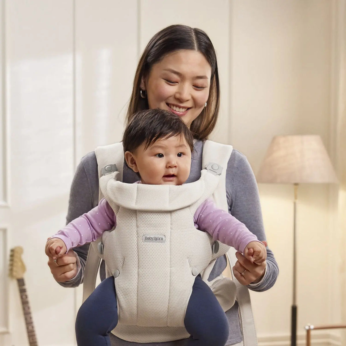 Baby facing out in the BabyBjorn Baby Carrier Hold Cream