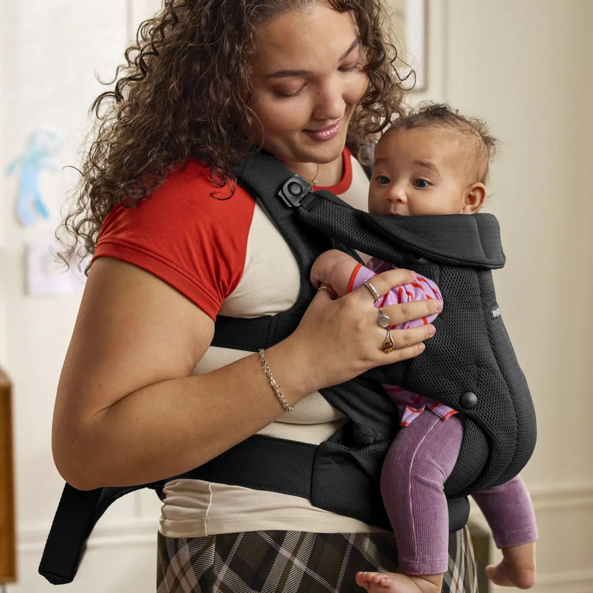Baby facing in, snug in the BabyBjorn Baby Carrier Hold Black