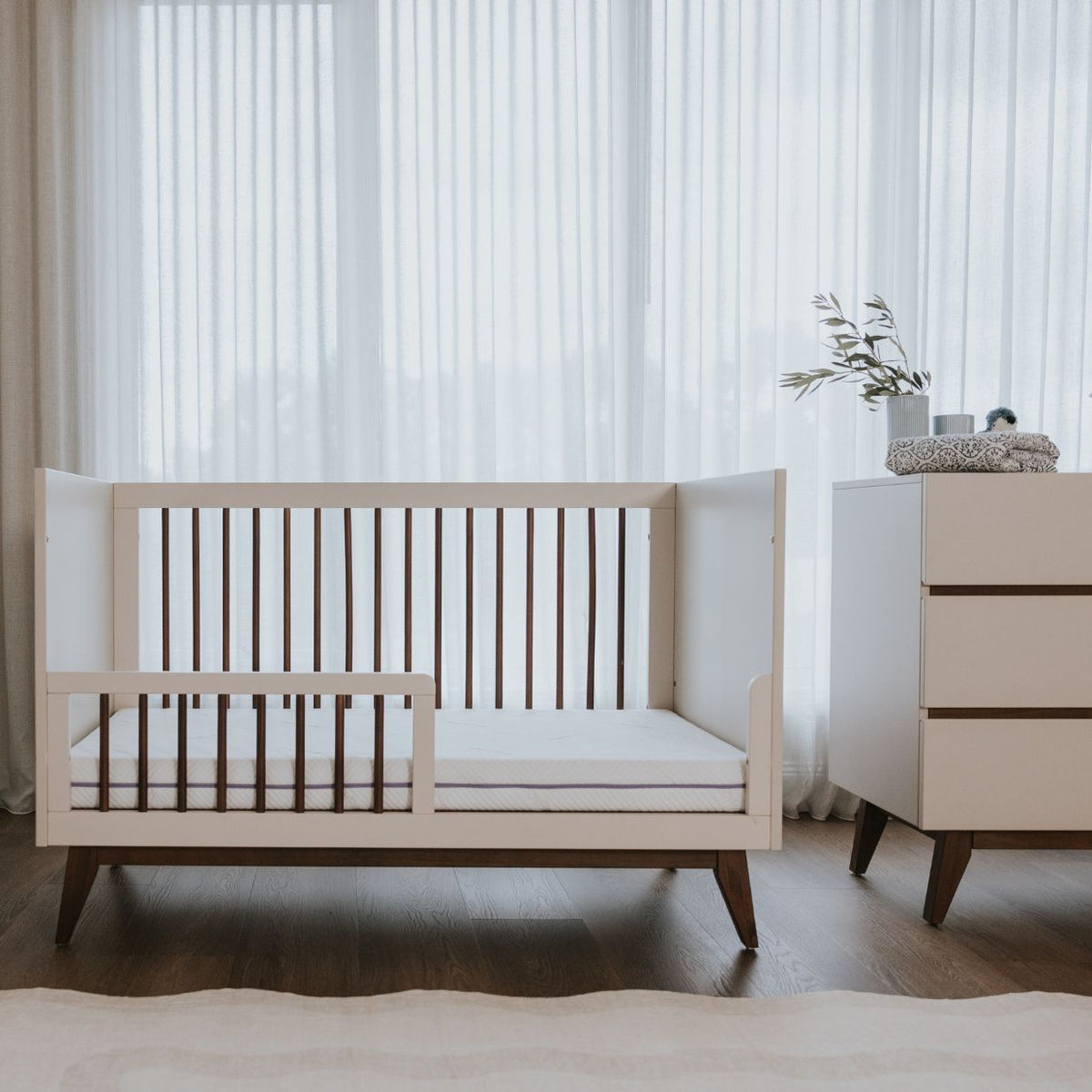 Babyrest Hugo Cot converted to a junior bed with the bedrail