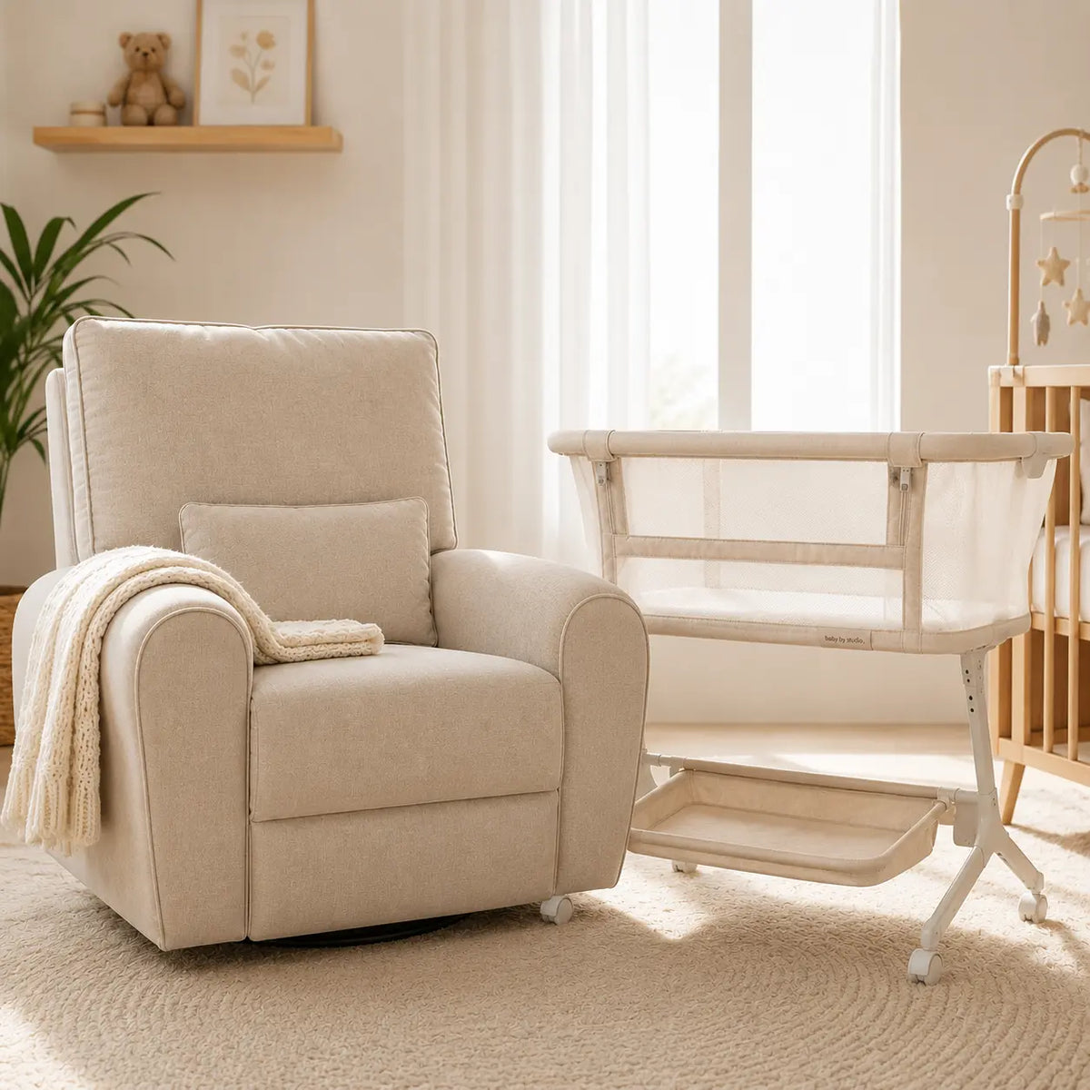 Babystudio Dream Glider bassinet in Sand styled in a nursery beside a nursing chair
