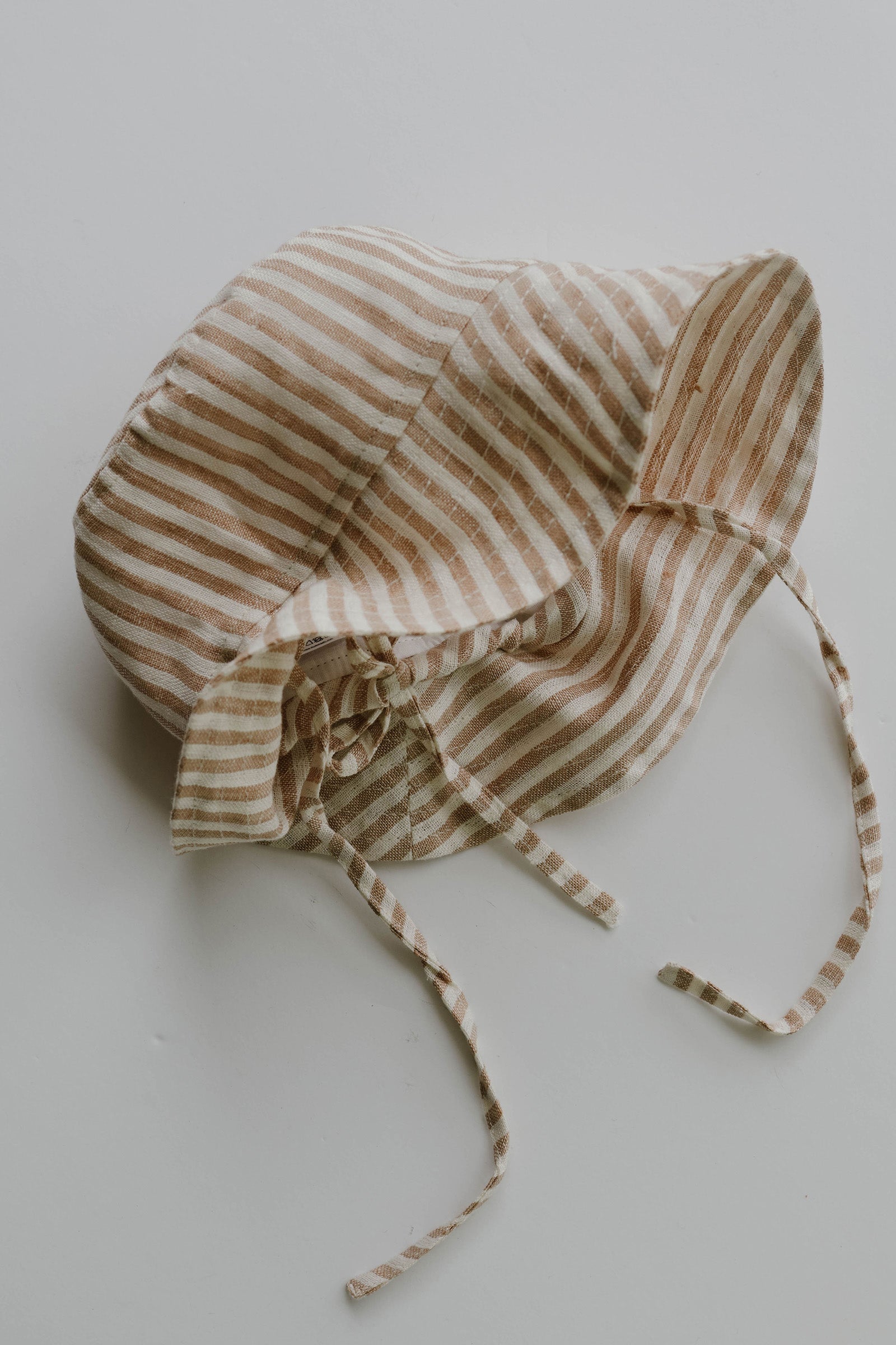Toddler in the Mumma Etcetera Baby & Toddler Hat in Burleigh, adjustable linen sun hat