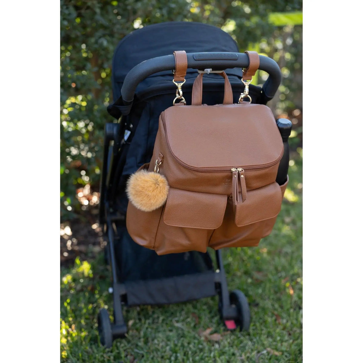 Coco Mae bag charm on a nappy backpack, lifestyle