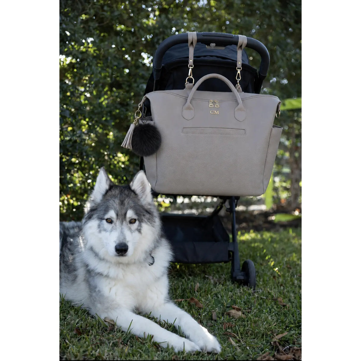 Coco Mae bag charm on a tote nappy bag with a pram