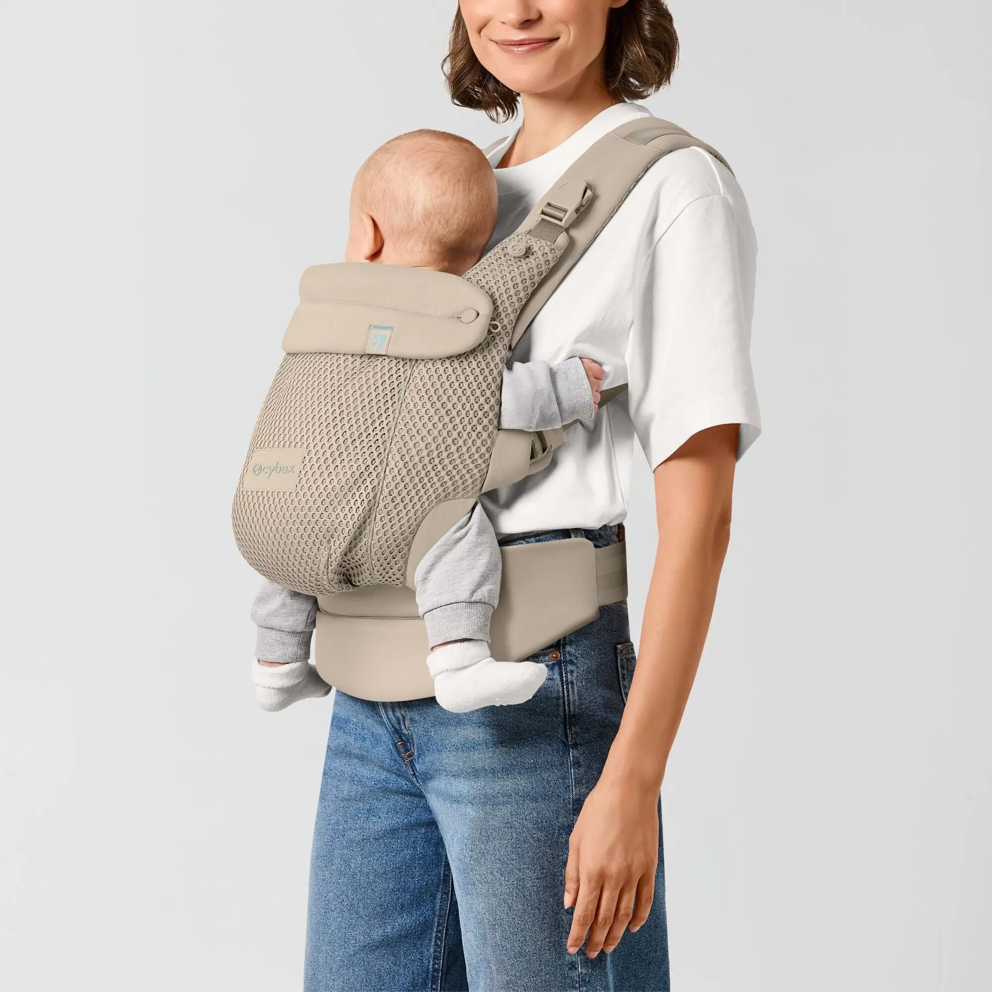 Front inward carry position with an older baby in the Amya carrier, Almond Beige