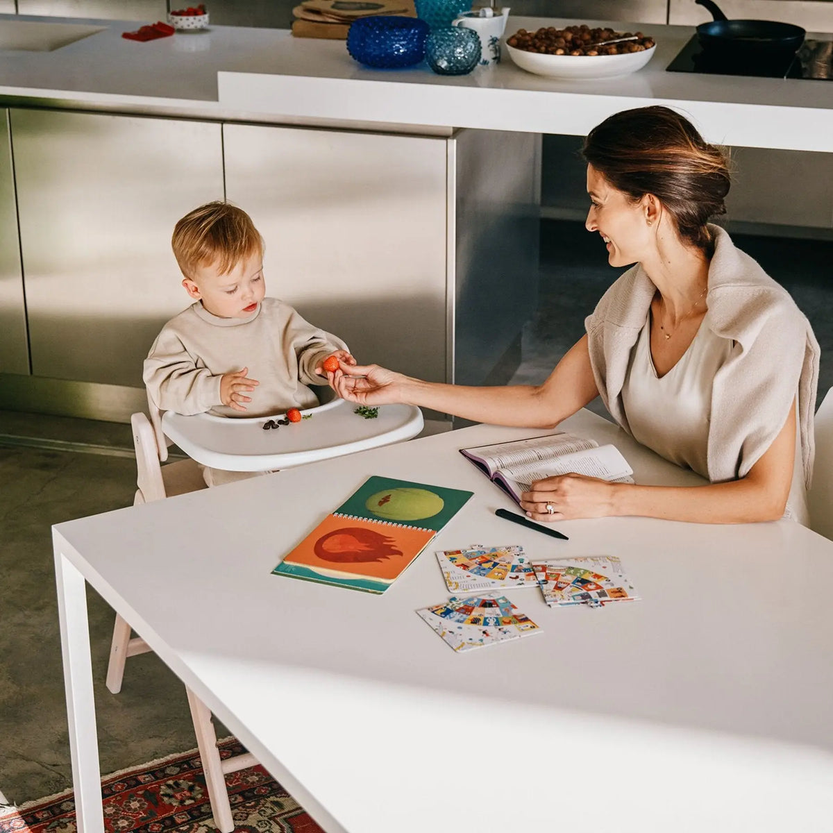 Toddler at the table in the Cybex Click & Fold high chair with Baby Set and tray