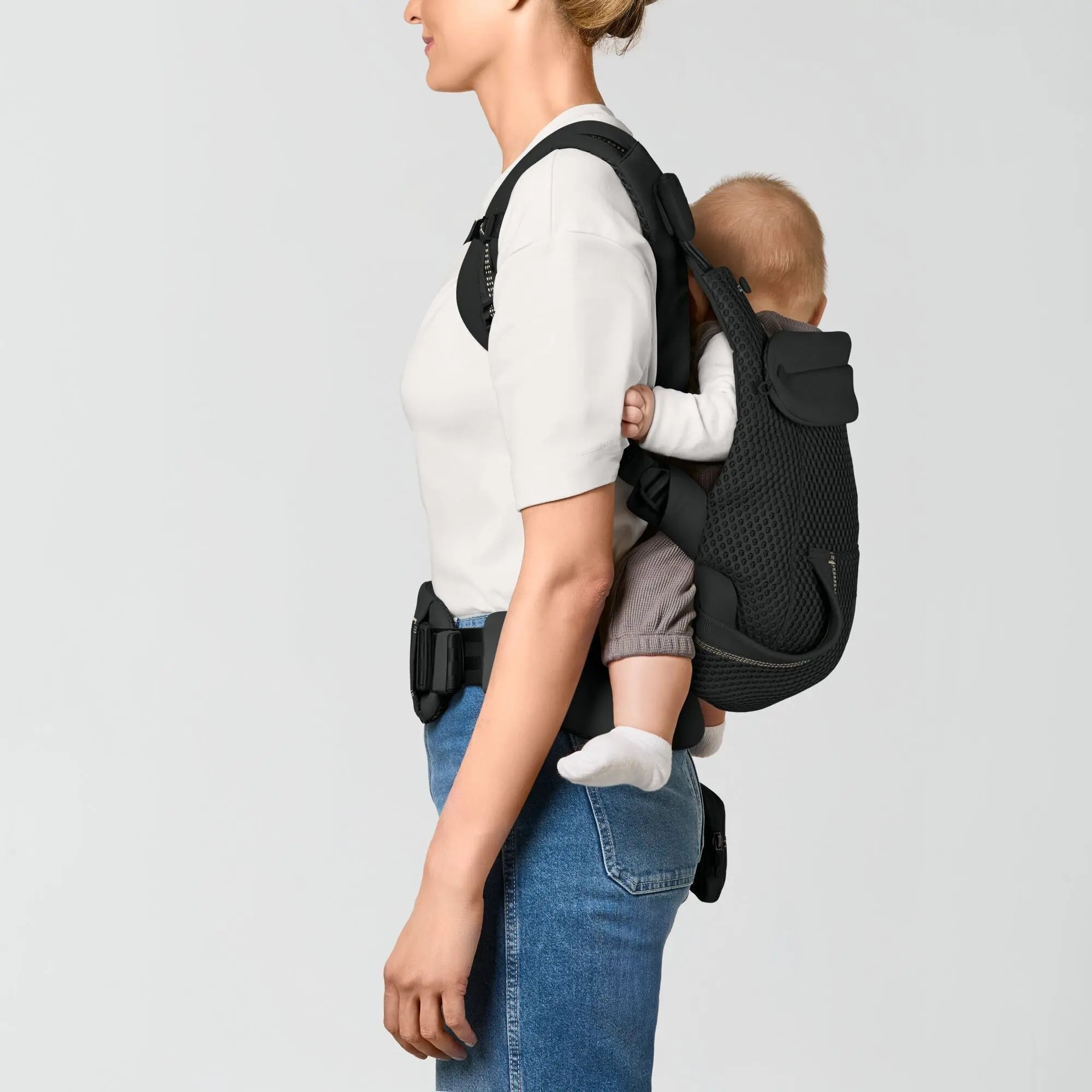 Toddler in the back inward carry position in the CYBEX Laya baby carrier