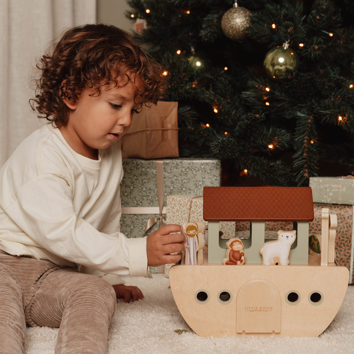 Toddler playing with the Little Dutch wooden Noah's Ark