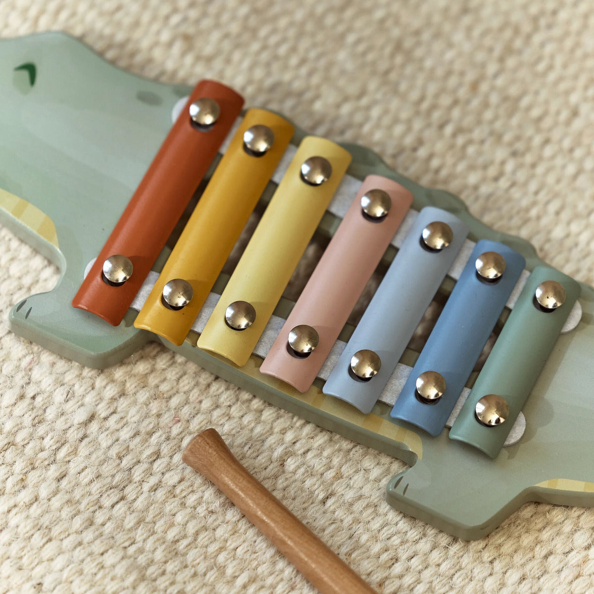 Toddler playing the wooden xylophone
