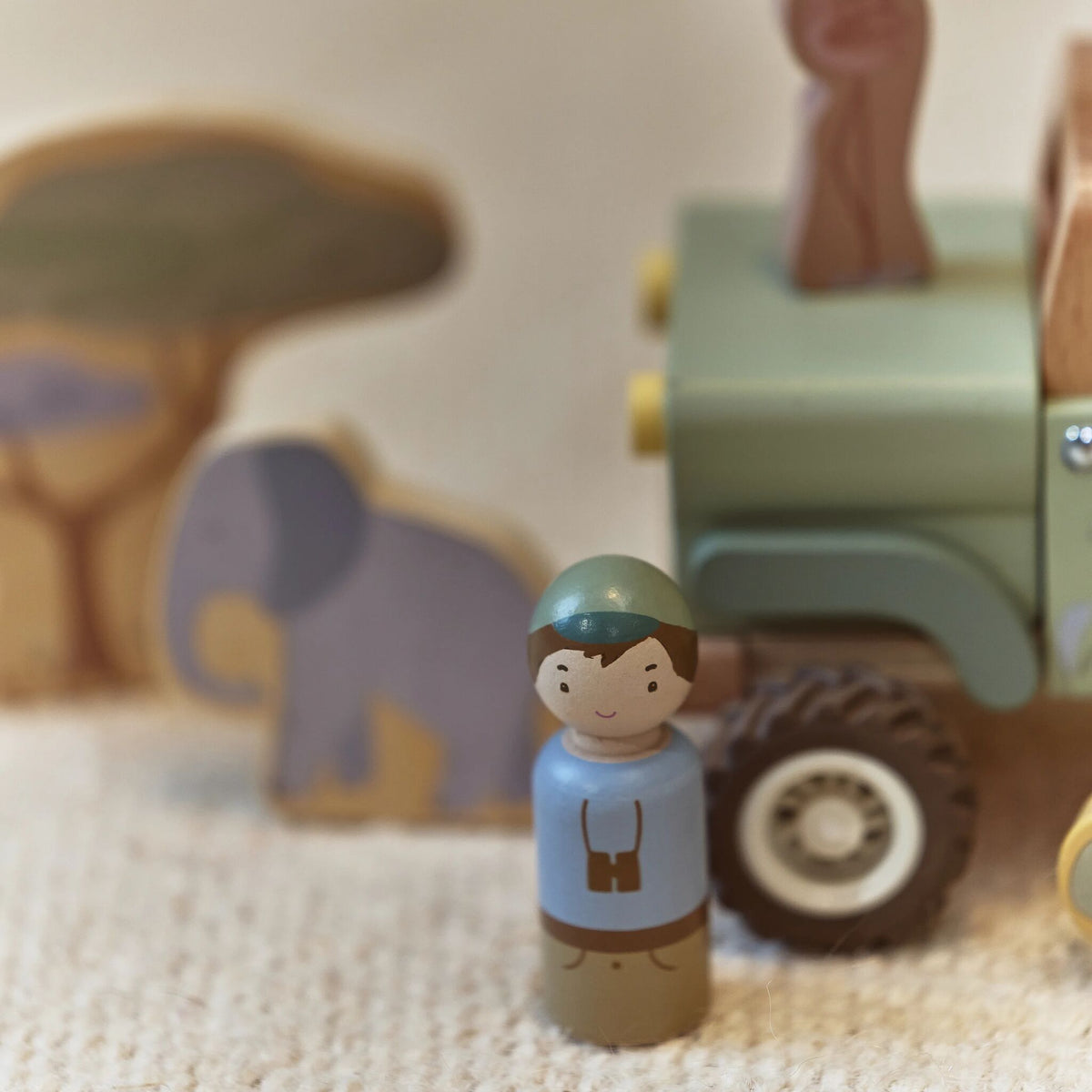 Toddler playing with the wooden safari car and animals