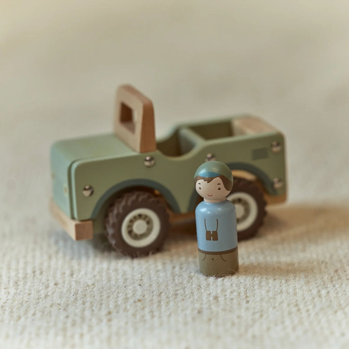 Toddler playing with the wooden safari car