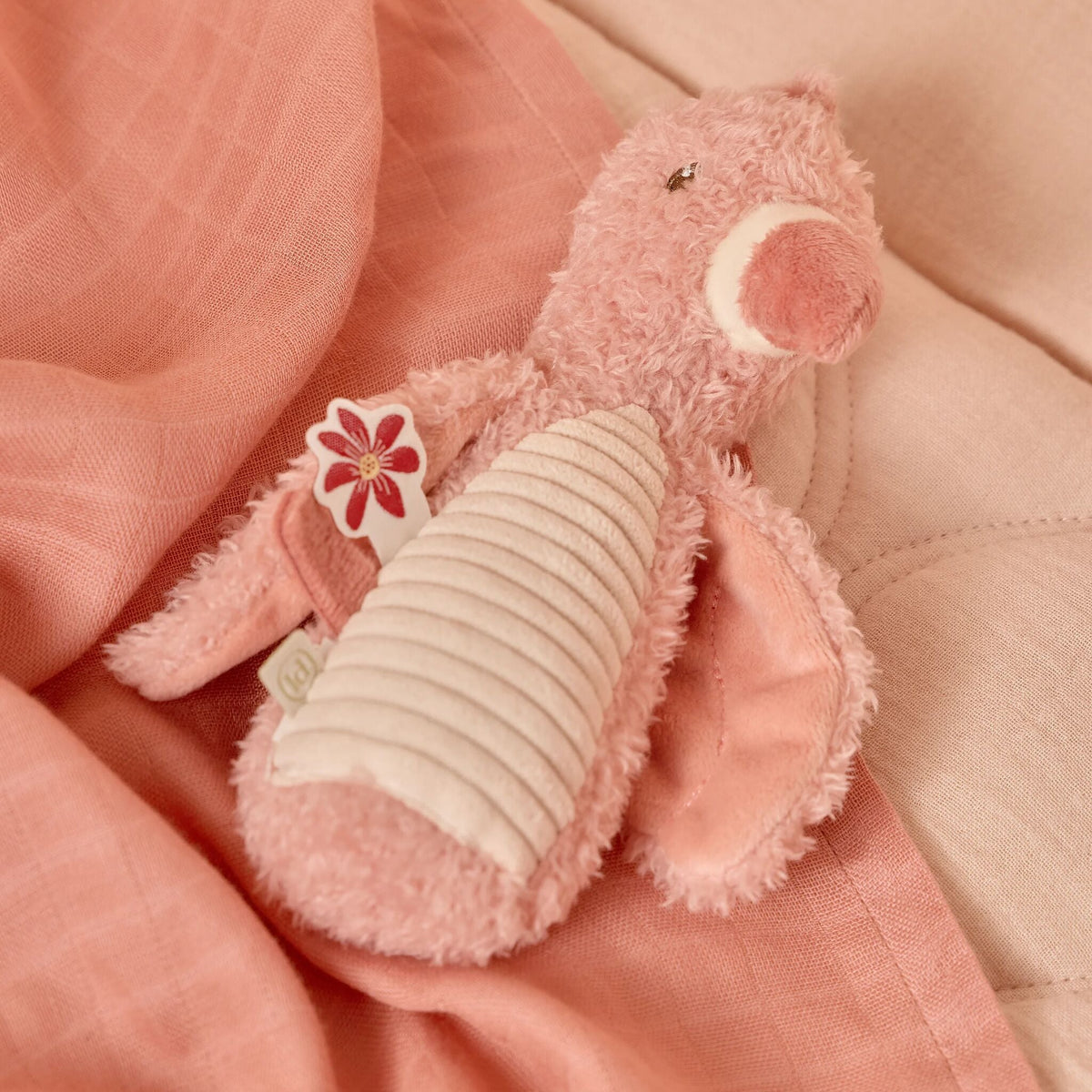 Baby holding the flamingo squeaker rattle