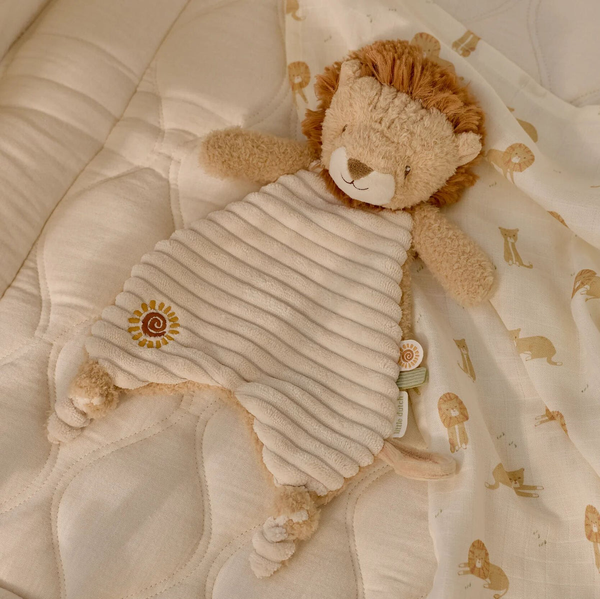 Baby holding the Little Dutch lion comforter