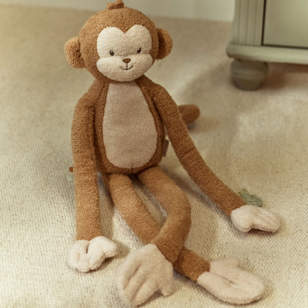 Cuddle Monkey XL holding a toy