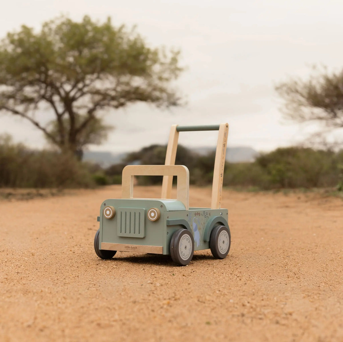 Toddler pushing the wooden safari car