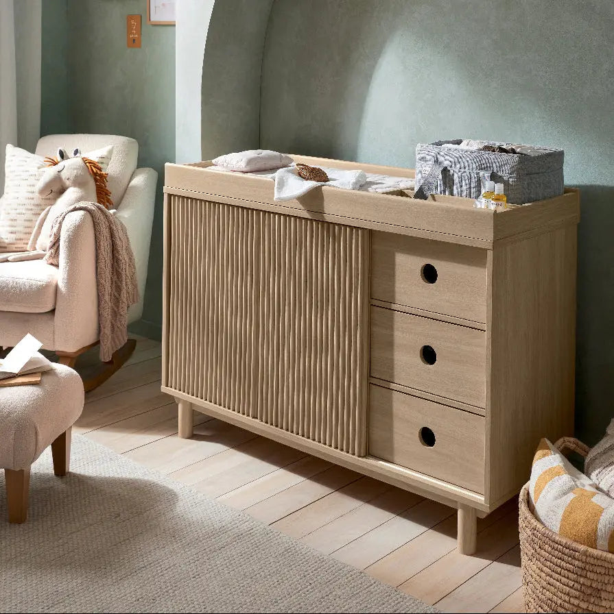 Oska wide dresser changer oak styled in a modern nursery