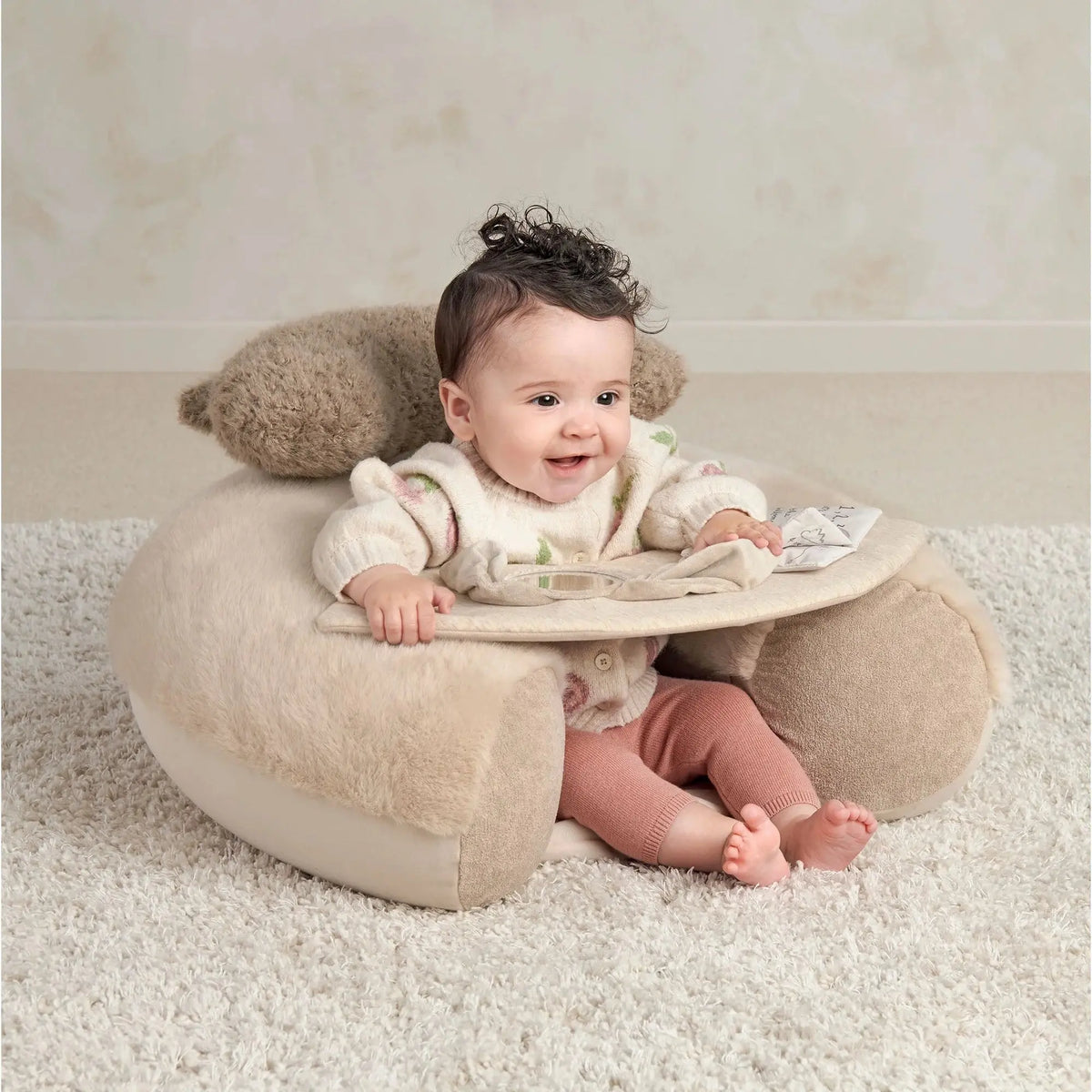 Mamas & Papas Sit & Play floor seat in Welcome to the World Millie & Boris, baby sitting up on the floor seat on a rug