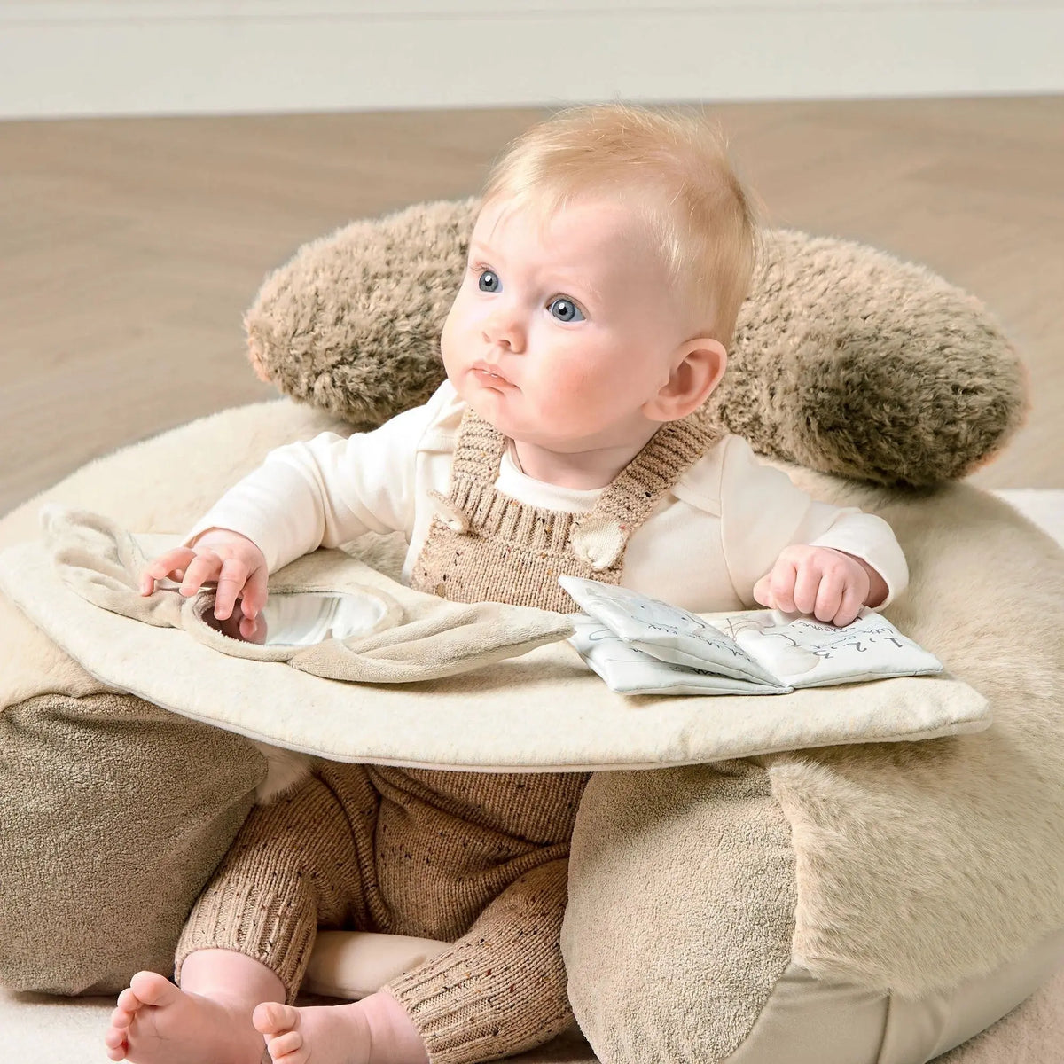 Mamas & Papas Sit & Play floor seat in Welcome to the World Millie & Boris, baby sitting in the seat looking to the side