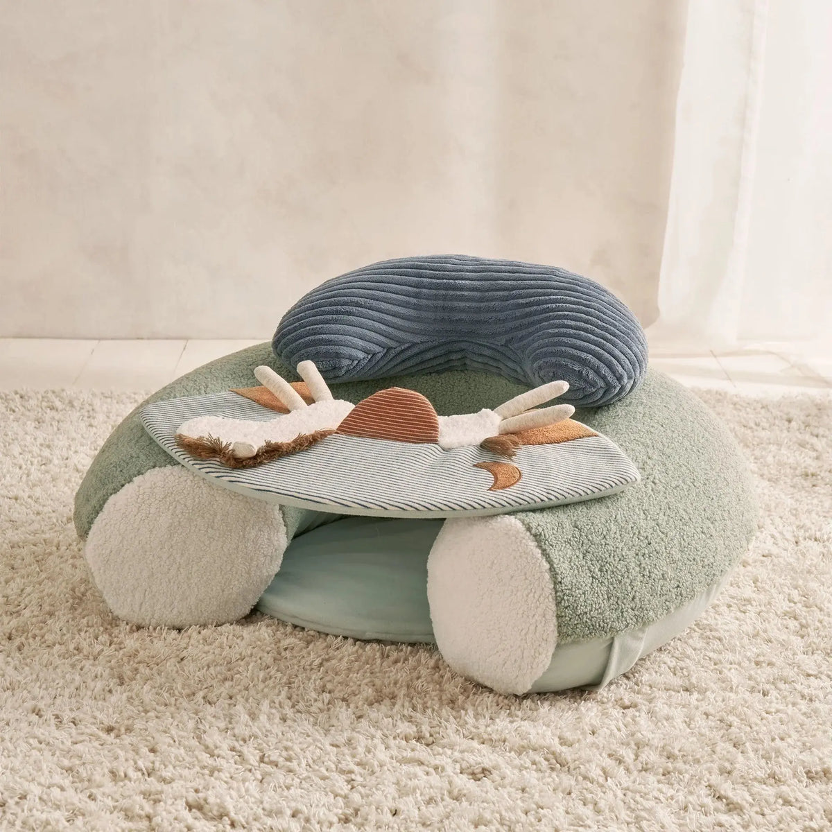 Mamas & Papas Sit & Play floor seat in Welcome to the World Pony Express, floor seat on a rug, three-quarter view