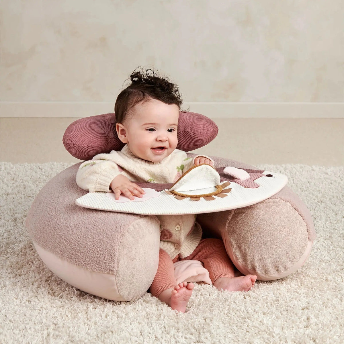 Mamas & Papas Sit & Play floor seat in Welcome to the World Floral, baby sitting up on the floor seat on a rug