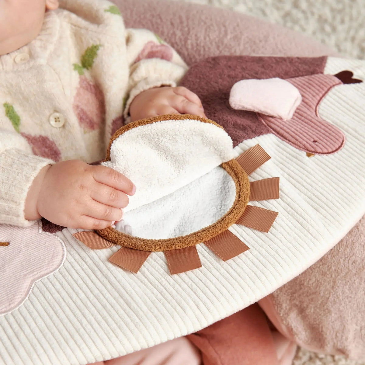 Mamas & Papas Sit & Play floor seat in Welcome to the World Floral, baby playing with the sun mirror on the tray