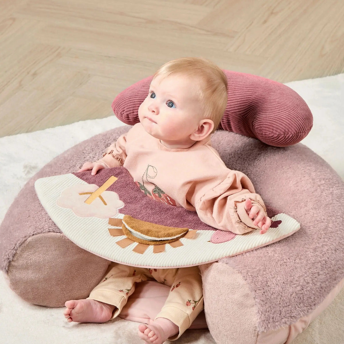 Mamas & Papas Sit & Play floor seat in Welcome to the World Floral, baby sitting in the seat playing with the tray