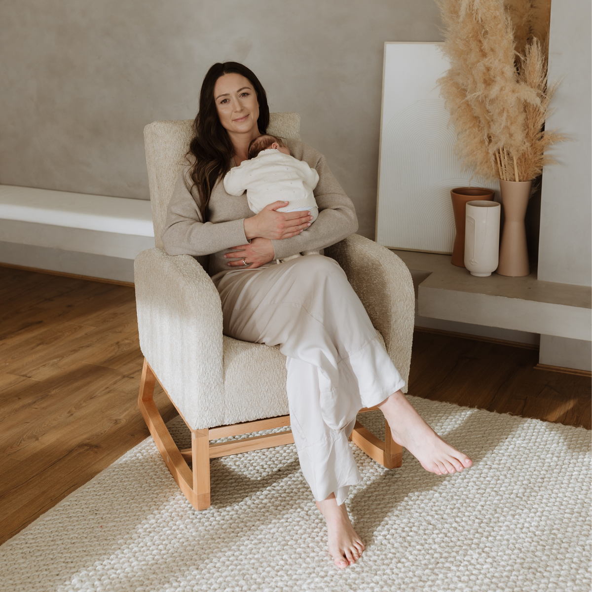 Mum feeding a newborn in the Cariboo Myla boucle nursing chair