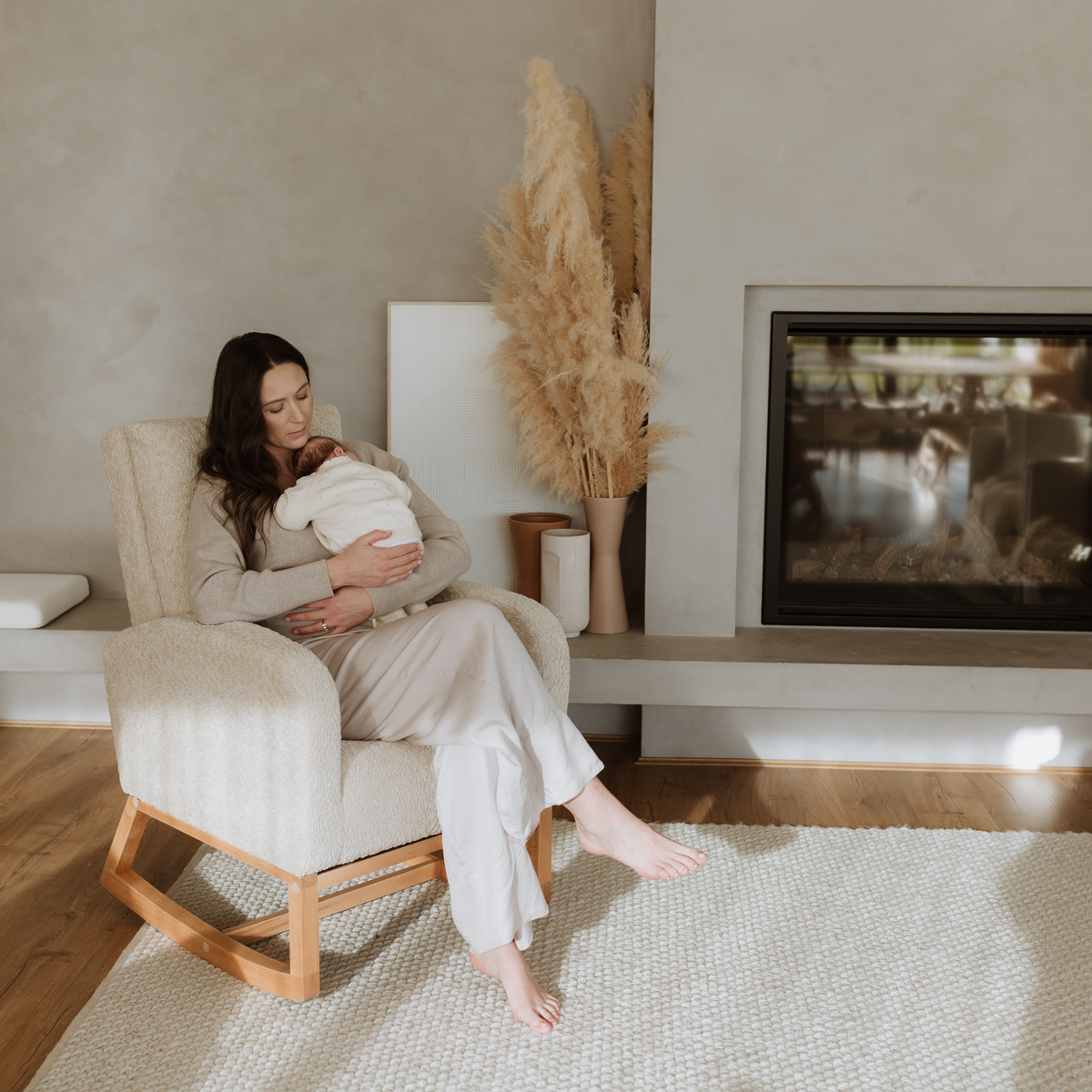 Mum holding a newborn in the Cariboo Myla nursery rocking chair