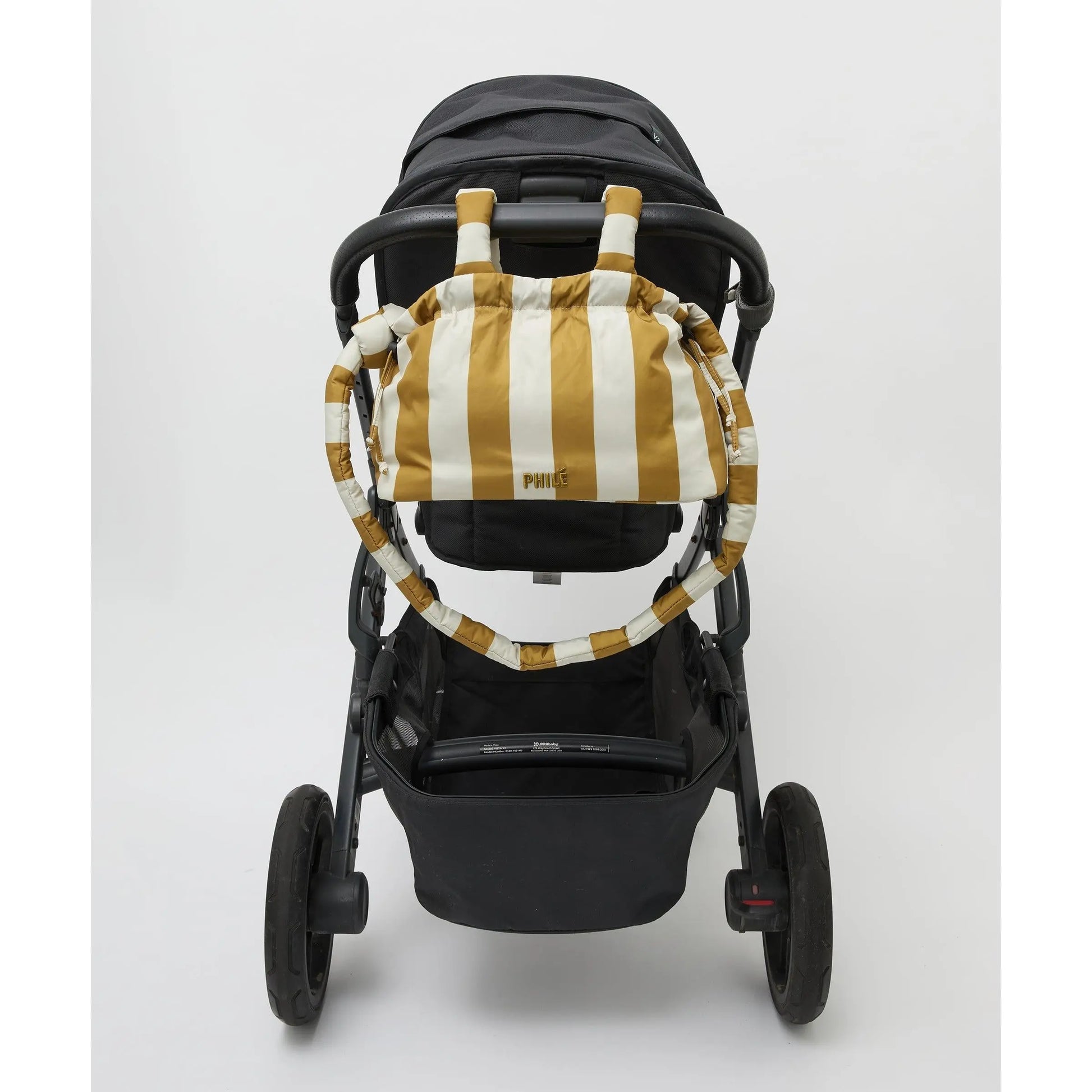 Philé Pram Caddy in Gold Stripe, worn as a crossbody bag