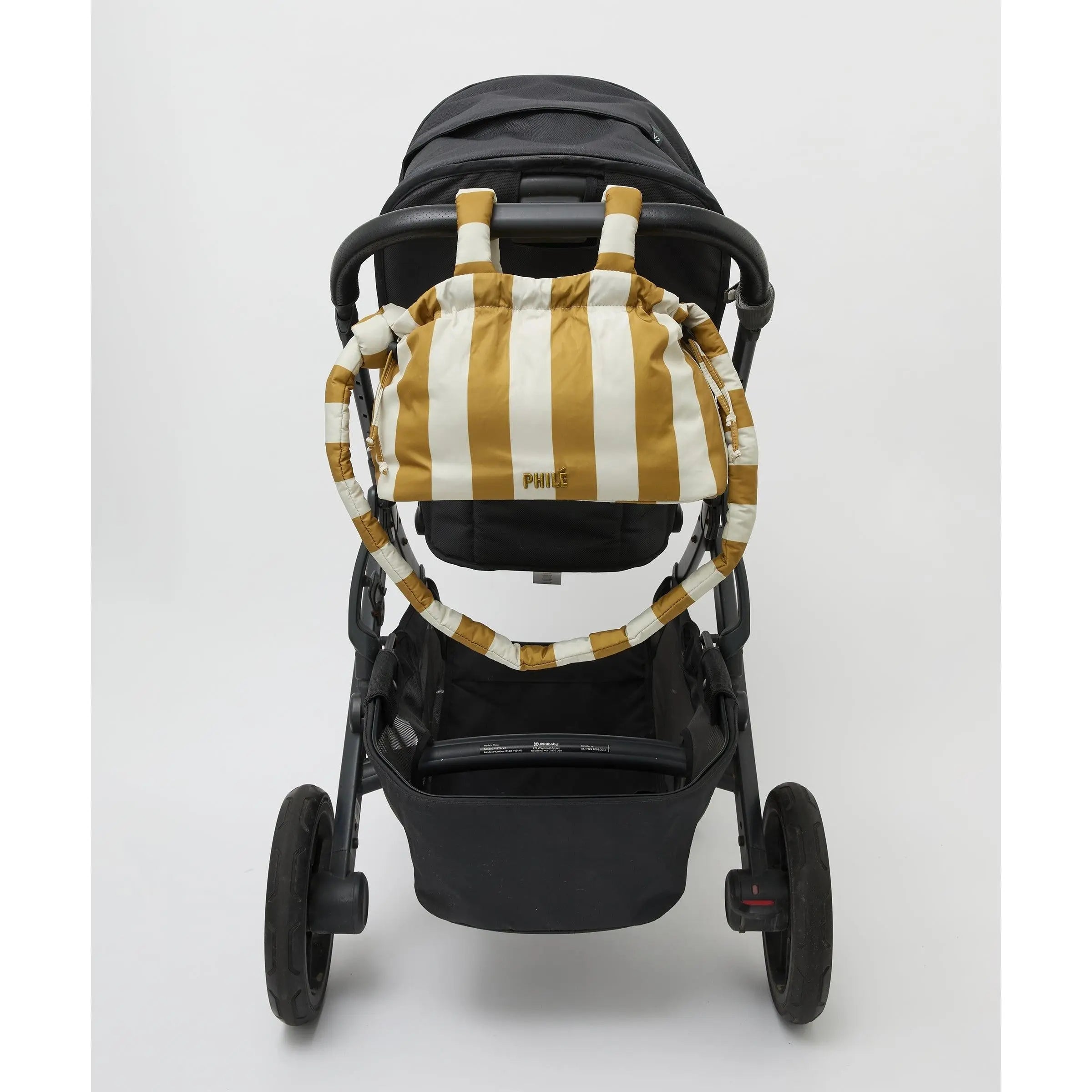 Philé Pram Caddy in Gold Stripe, worn as a crossbody bag