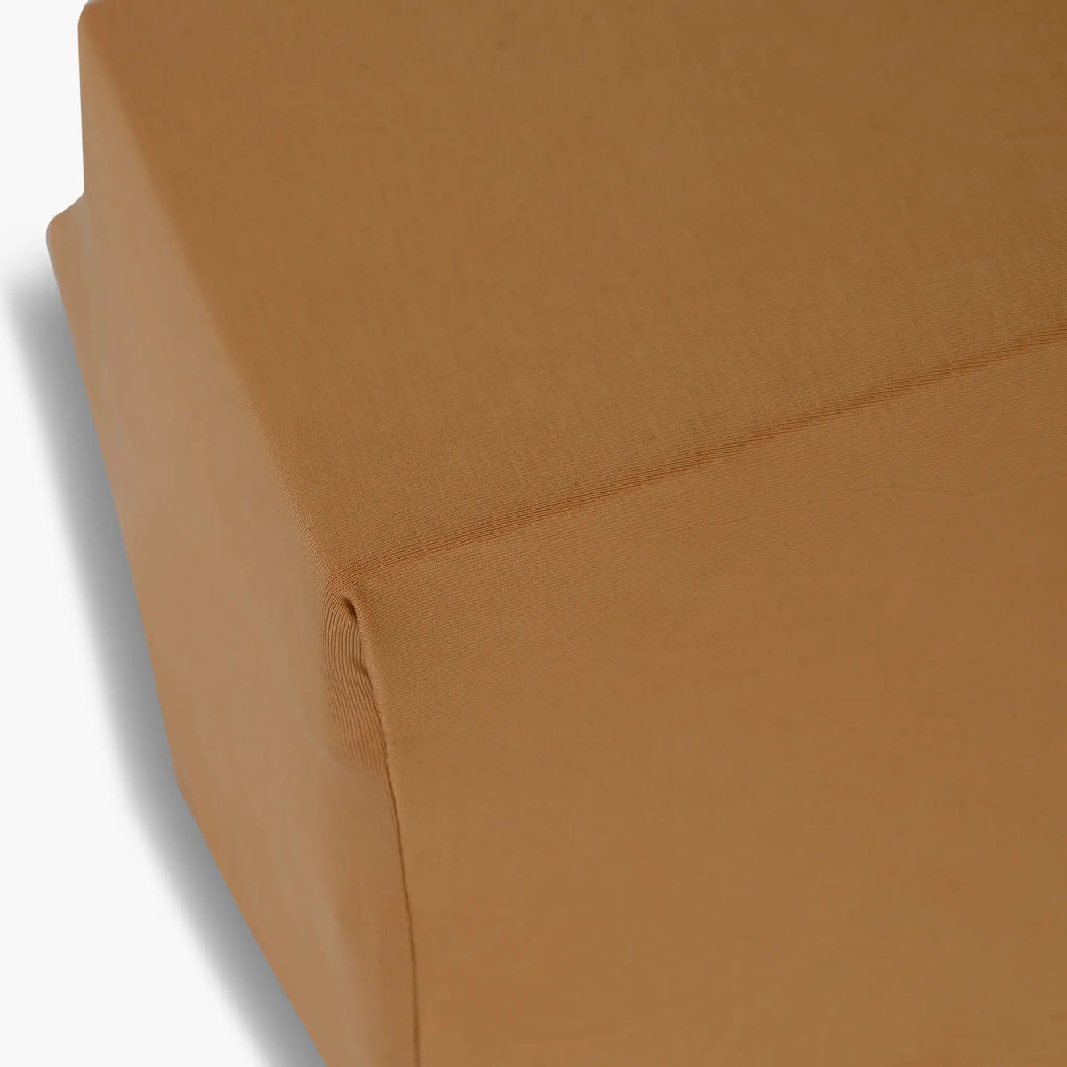 Seena Burnt Caramel fitted sheet on a cot mattress corner