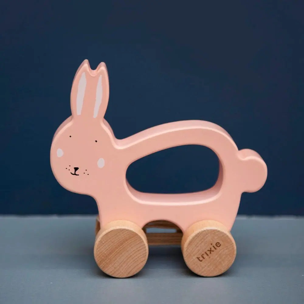 Toddler pulling Trixie Mrs. Rabbit wooden toy by cotton string – first walking companion