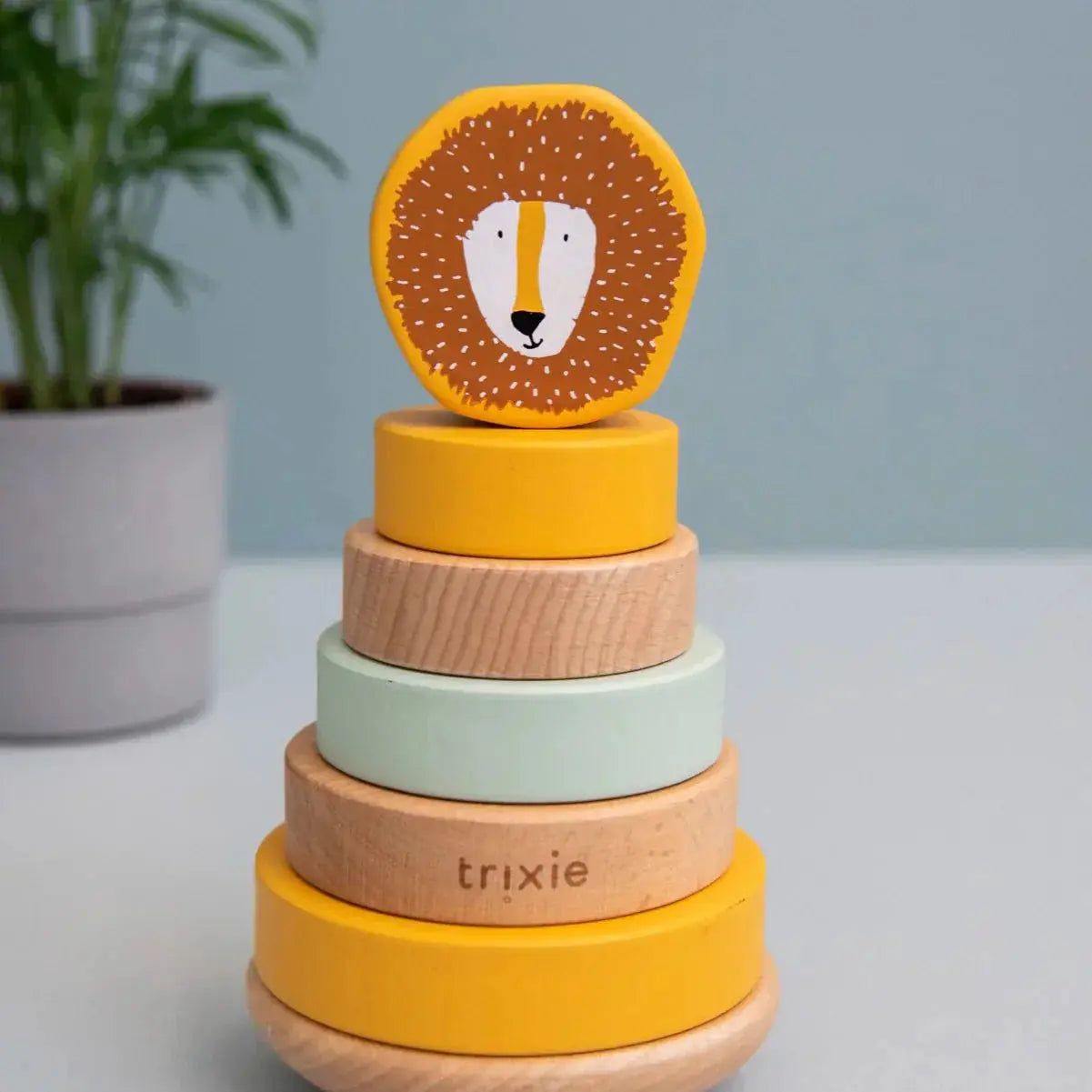 Side view of Trixie Mr. Lion wooden ring stacker showing curved wobble base