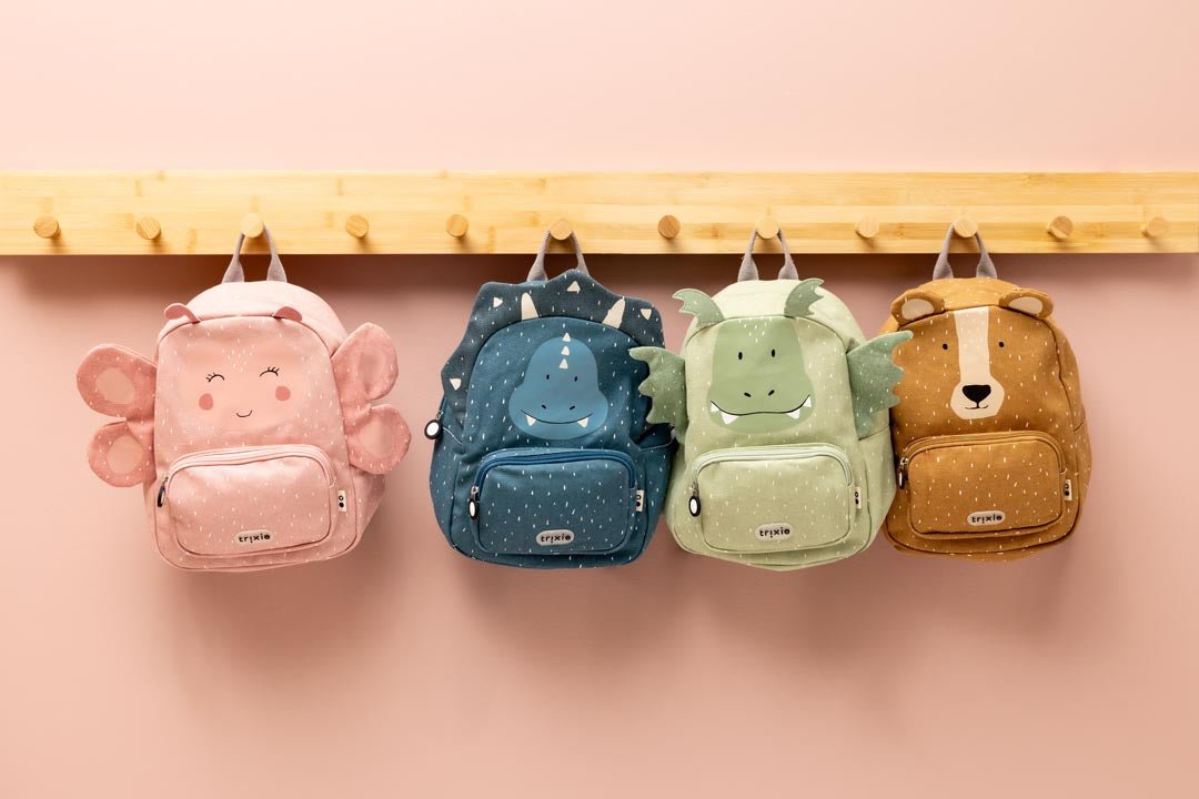 Child wearing Trixie Mr. Triceratops backpack – recycled cotton kids school bag