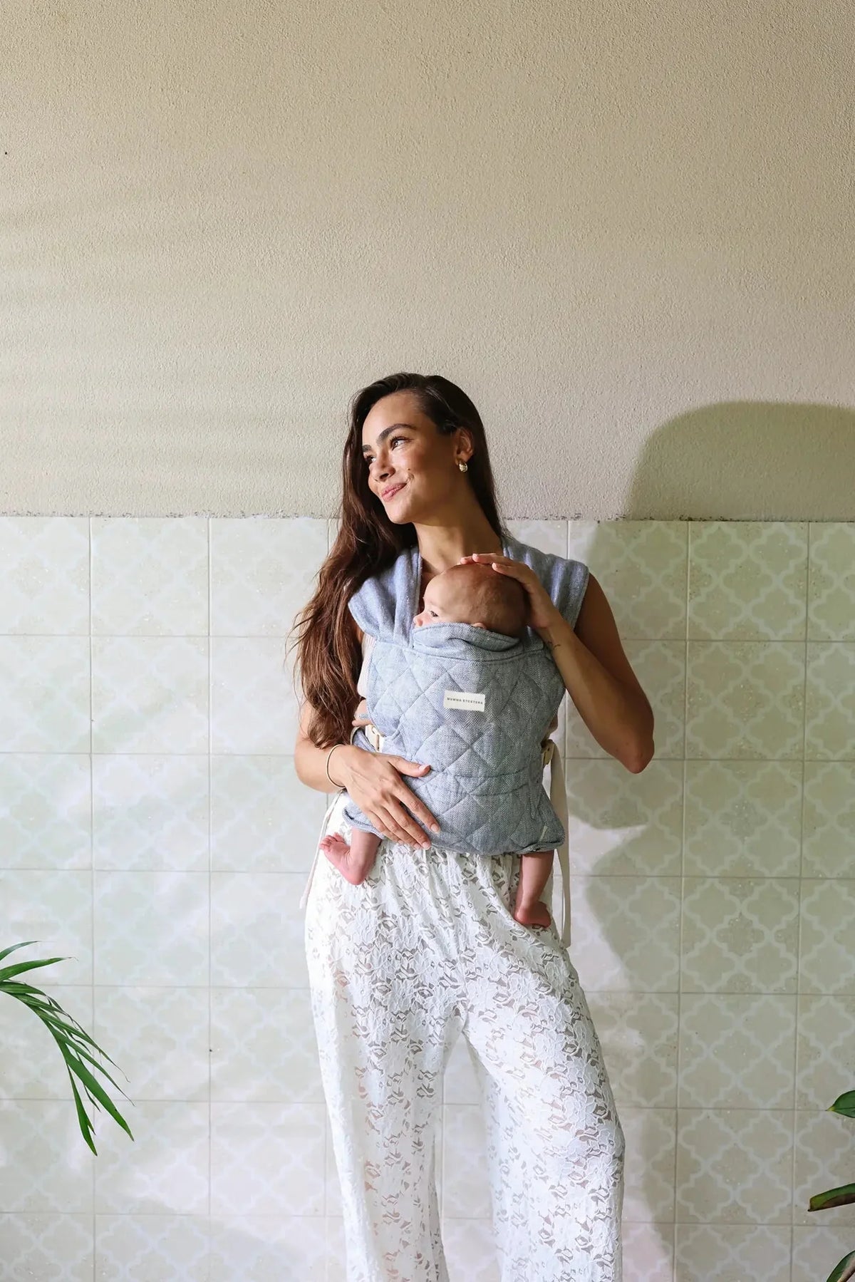 Close-up of newborn settled in the Lane Daily Carrier quilted bodice