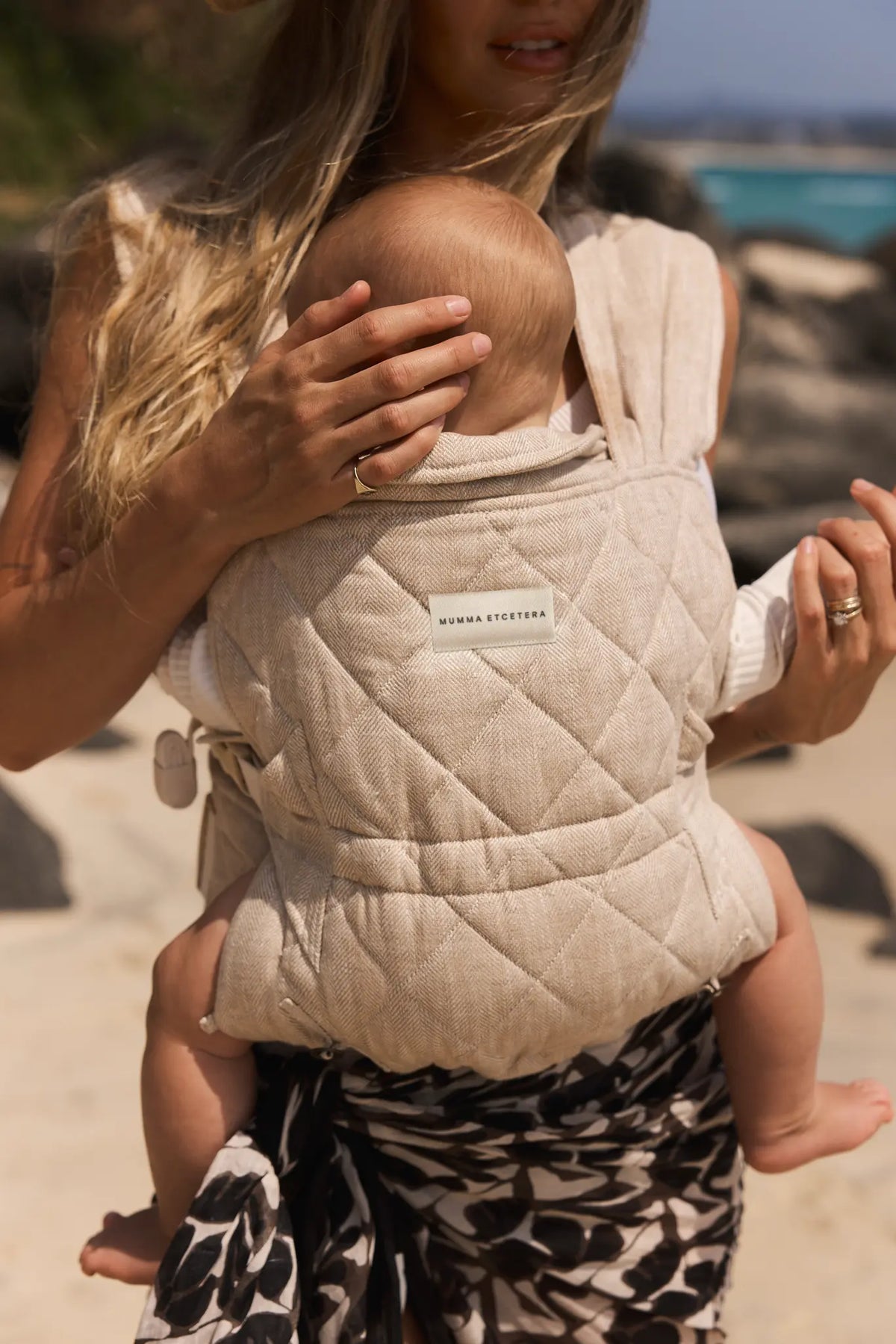 Meadow linen Daily Carrier worn at the beach, quilted panel and rolled headrest