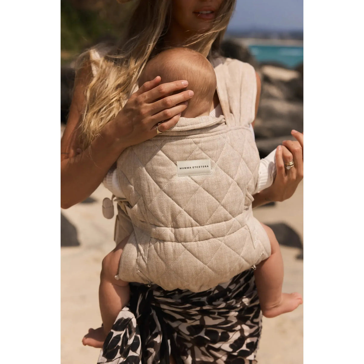 Meadow linen Daily Carrier worn at the beach, quilted panel and rolled headrest