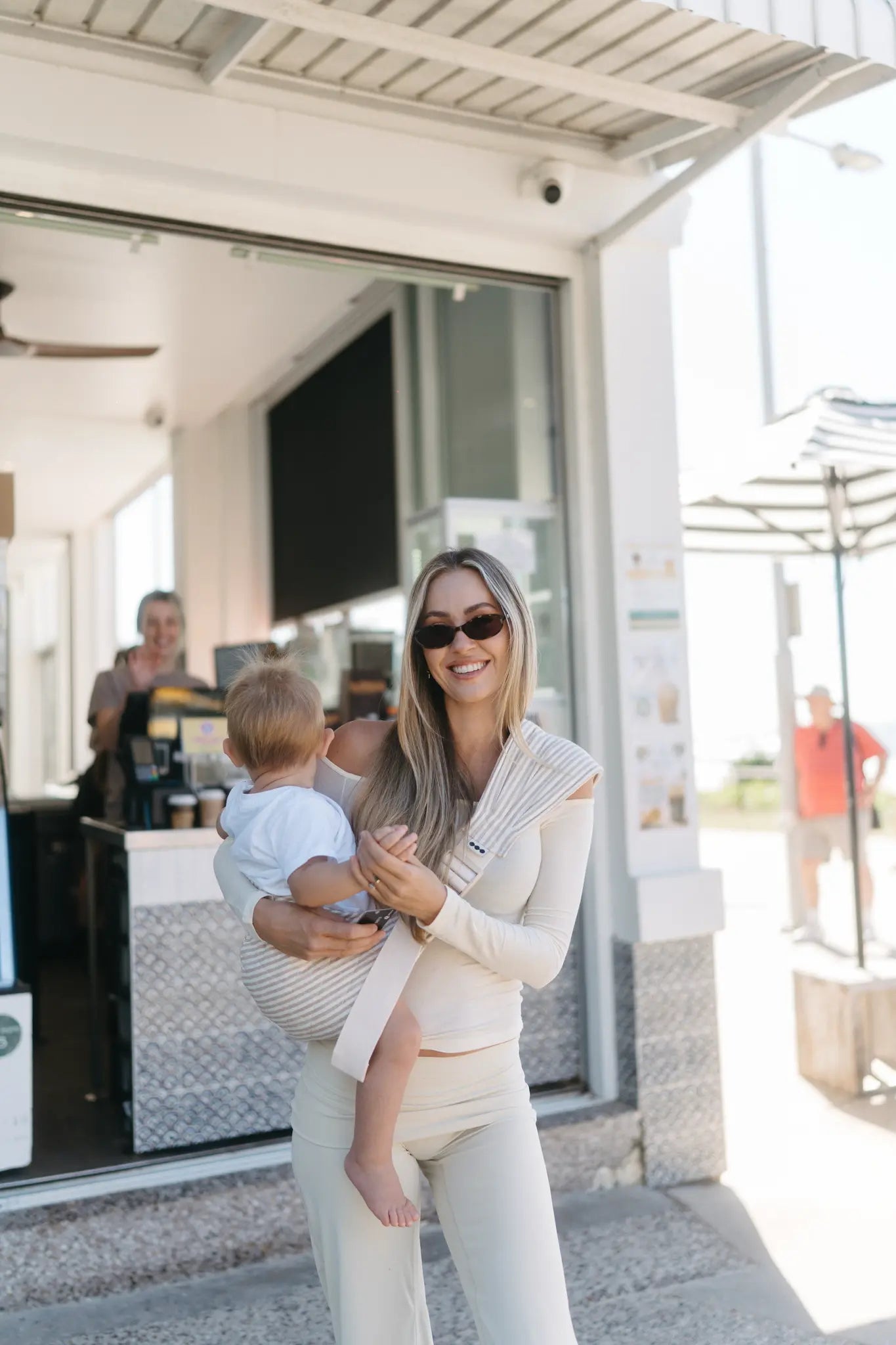 Toddler carried on hip in the Burleigh stripe Mumma Etcetera Hipsy hip carrier