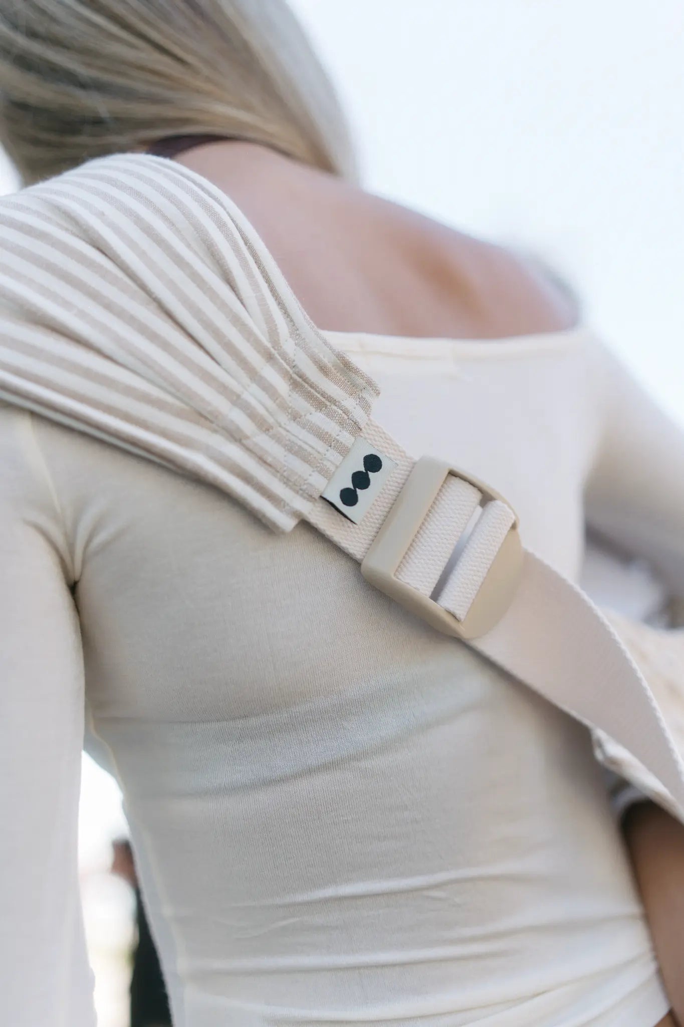 Close-up of the wide cupped shoulder strap on the Burleigh stripe Mumma Etcetera Hipsy Carrier