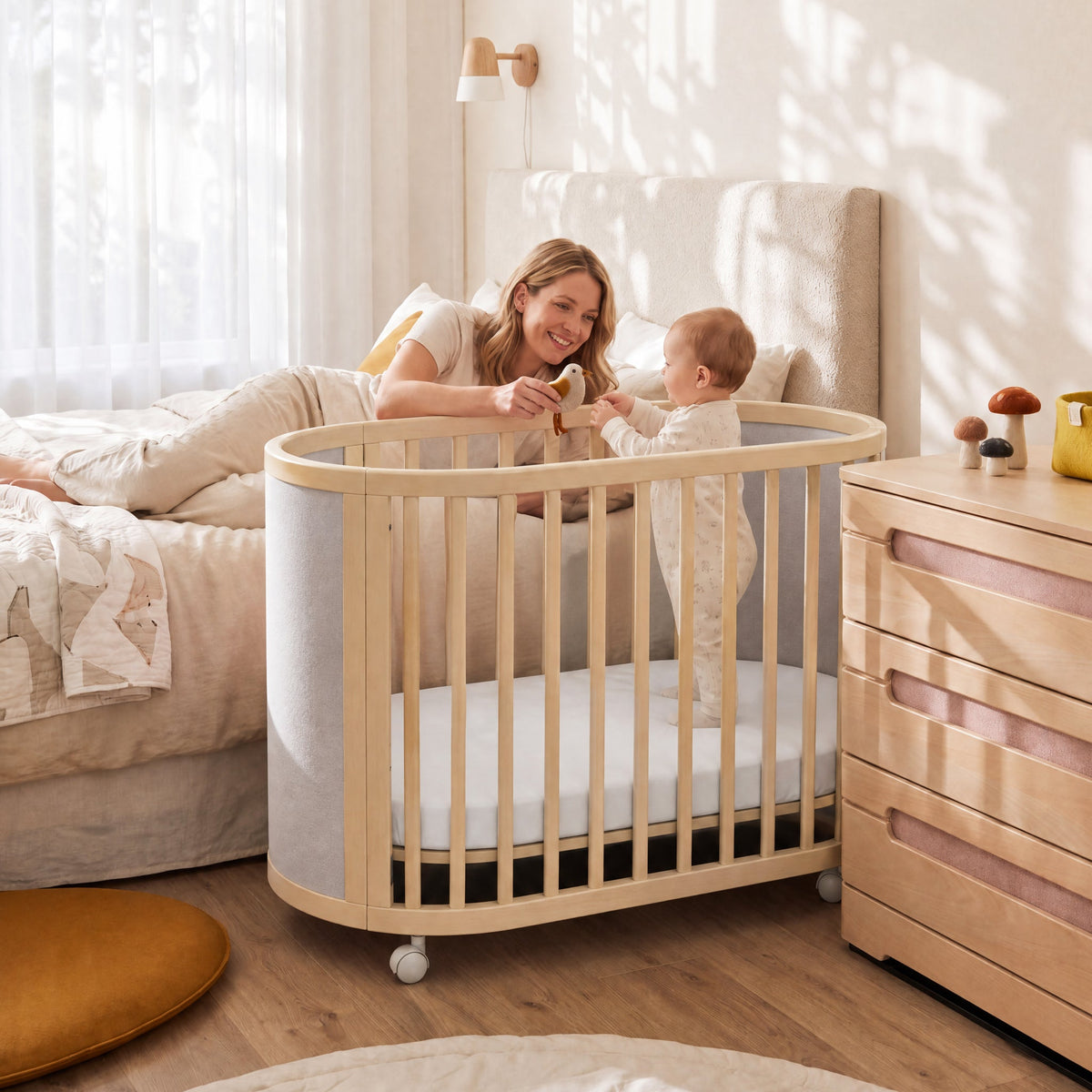 Family relaxing beside the Eden Elite Oval Cot