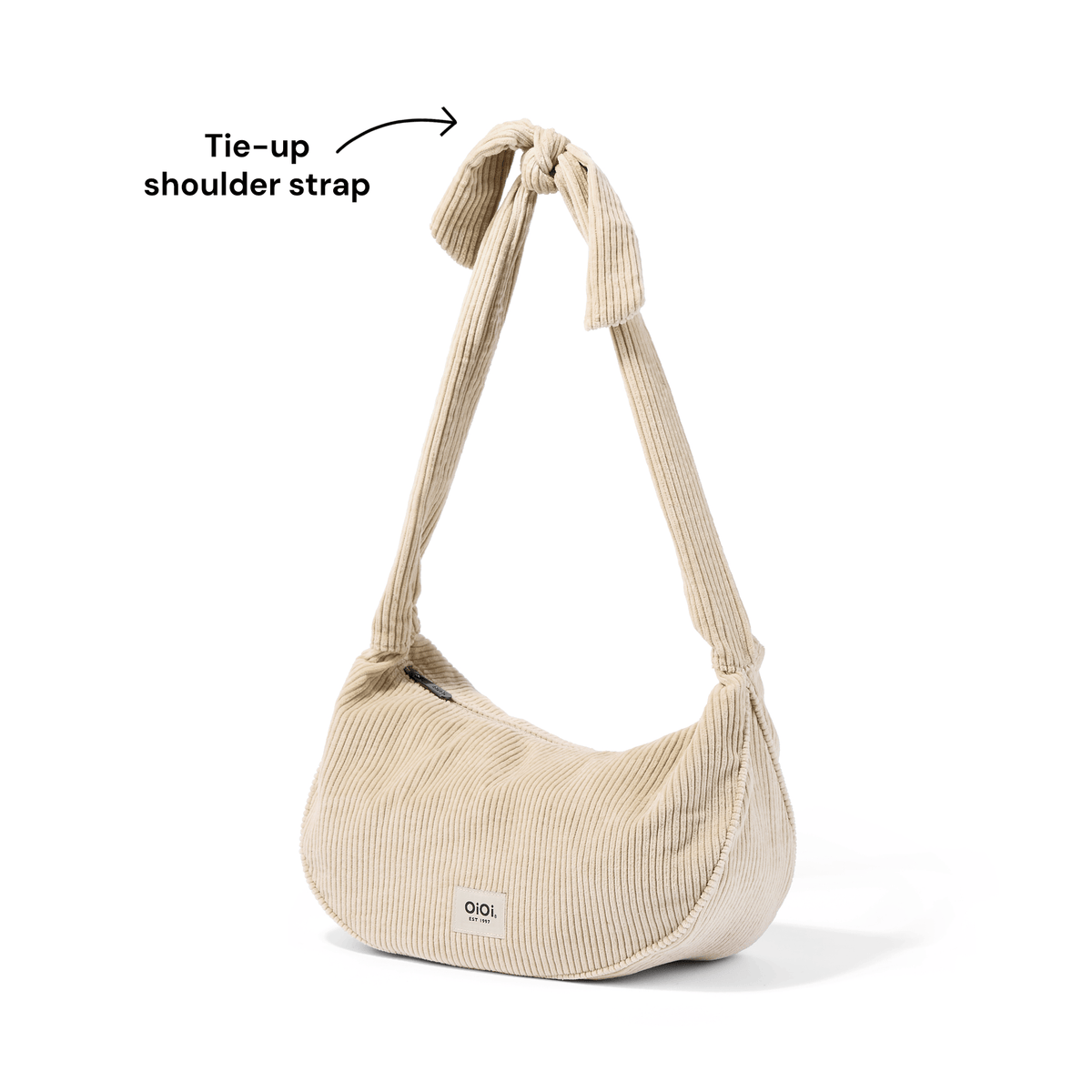 OiOi Luna Crossbody adjustable tie-up shoulder strap detail in Cream